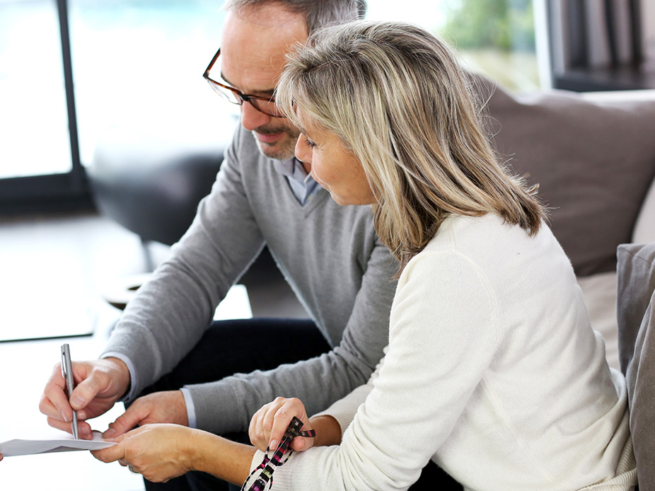 Mature couple signing papers